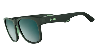 Mint Julep Electroshocks goodr sunglasses in dark green with blue gradient lenses, angled on a white background.