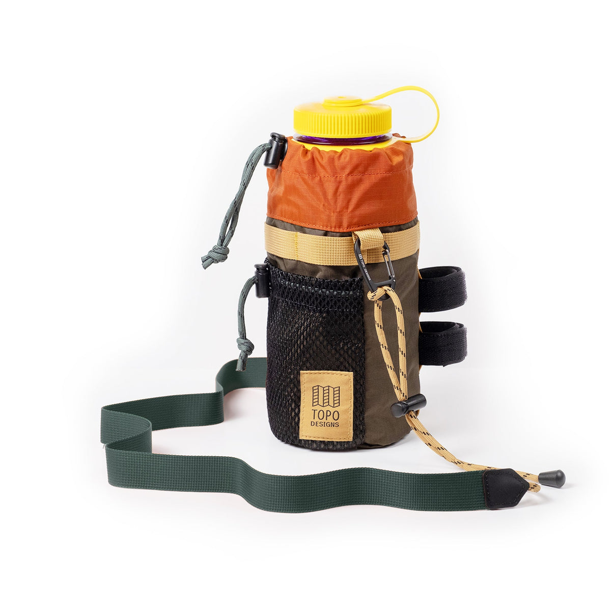 Topo Designs Mountain Hydro Sling, a multi-color bottle holder with a yellow-capped Nalgene bottle, mesh pocket, and shoulder strap.