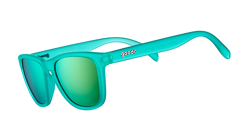 Nessy's Midnight Orgy goodr sunglasses featuring a vibrant teal frame and reflective green lenses, angled view.