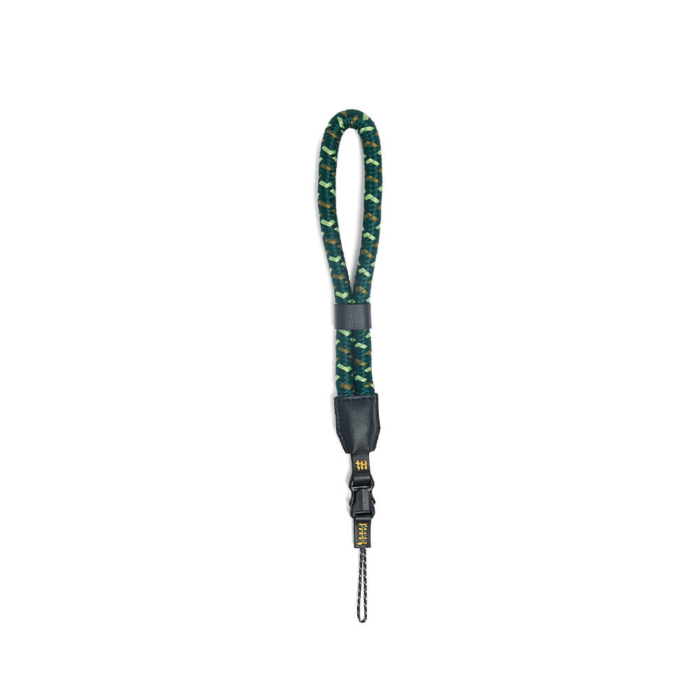 NocLoc Approach Wrist Loop by Nocs Provisions. A green and brown patterned rope wrist strap with black leather accents and buckle.