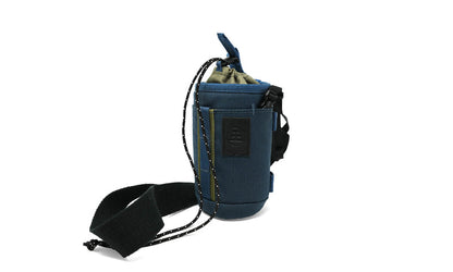 Nocs Provisions Tube Caddy in blue and olive green, a versatile bag for carrying bottles and essentials, with a black strap.