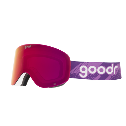 Vintage Snow Suit Ambitions goodr ski goggles with pink mirrored lens and patterned purple strap against a white background.