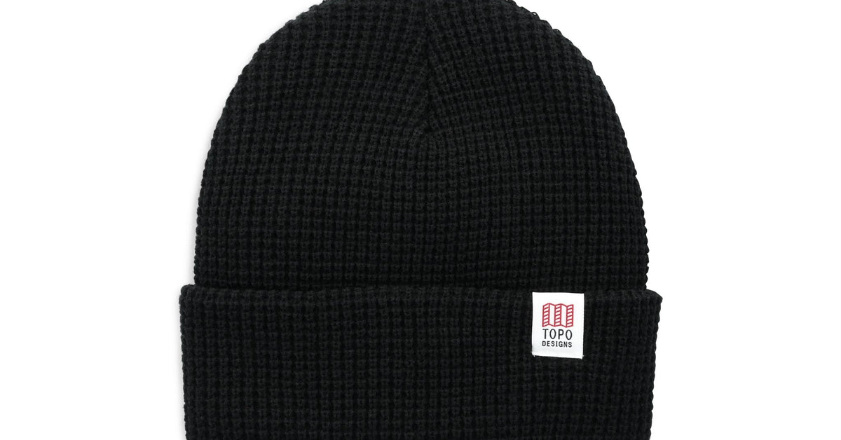 Black Topo Designs Waffle Knit Beanie with a white brand label on the folded brim.