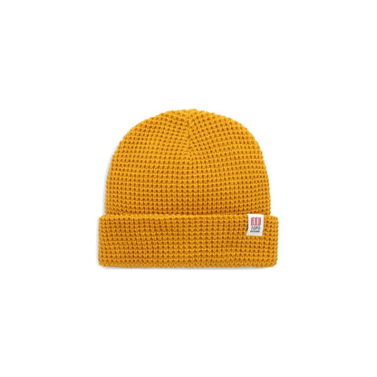Mustard yellow Waffle Knit Beanie by Topo Designs, featuring a textured knit pattern and branded label.