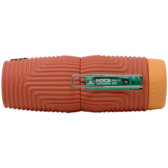 Nocs Provisions Zero Tube 10x25 Waterproof Monocular, top view showing textured orange body and green logo clip.